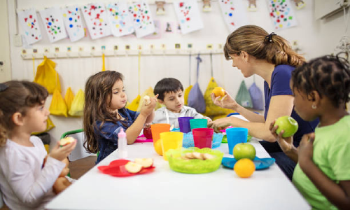 Children enjoying a meal together at NurtureNest