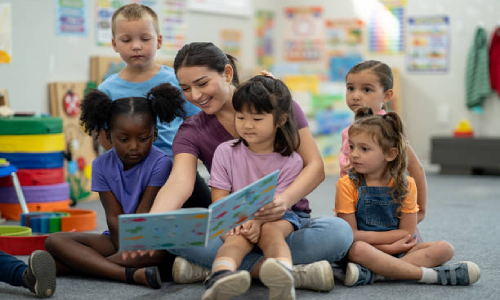 Kids having a story time with caregiver at NurtureNest